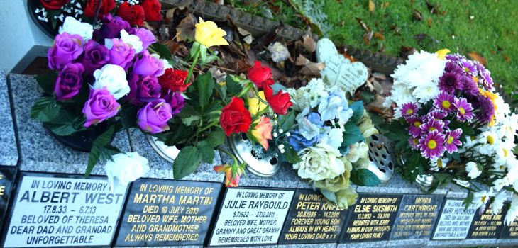 Memorials and flowers in the cemetery grounds